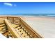 Inviting beach access from a wooden stairway, offering pristine sands and ocean views at 2545 S Atlantic Ave # 2107-2108, Daytona Beach Shores, FL 32118