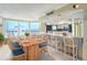 Dining Area with ocean view, adjacent to bar and kitchen, with wood table and seating for six at 2545 S Atlantic Ave # 2107-2108, Daytona Beach Shores, FL 32118