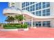 Grand entrance featuring a covered entryway, lush landscaping, and a brick-paved walkway at 2545 S Atlantic Ave # 2107-2108, Daytona Beach Shores, FL 32118