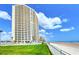 Luxury beachfront high-rise condo building with ocean views, private balconies, and manicured grounds at 2545 S Atlantic Ave # 2107-2108, Daytona Beach Shores, FL 32118