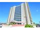 Stunning high-rise condo building featuring many windows and balconies under a bright blue sky at 2545 S Atlantic Ave # 2107-2108, Daytona Beach Shores, FL 32118