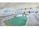 An indoor pool surrounded by lounge chairs, offering relaxation with ocean views at 2545 S Atlantic Ave # 2107-2108, Daytona Beach Shores, FL 32118
