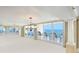 Open-concept living room with chandelier, floor-to-ceiling windows and sliding doors to a private balcony at 2545 S Atlantic Ave # 2107-2108, Daytona Beach Shores, FL 32118