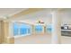 Bright living room with large windows offering ocean views, a ceiling fan, and classic architectural details at 2545 S Atlantic Ave # 2107-2108, Daytona Beach Shores, FL 32118