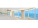 Bright living room with large windows offering ocean views and sliding door access to a private balcony at 2545 S Atlantic Ave # 2107-2108, Daytona Beach Shores, FL 32118