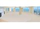 Open living room with large windows offering panoramic ocean views and access to a balcony at 2545 S Atlantic Ave # 2107-2108, Daytona Beach Shores, FL 32118