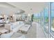 Bright living room features modern furnishings, floor-to-ceiling windows with city views, and wet bar at 2545 S Atlantic Ave # 2107-2108, Daytona Beach Shores, FL 32118