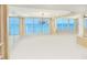 Living room featuring ocean views through large windows, an elegant chandelier, and modern finishes at 2545 S Atlantic Ave # 2107-2108, Daytona Beach Shores, FL 32118