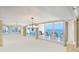 Bright living room featuring floor-to-ceiling windows with beautiful ocean views and neutral carpeting at 2545 S Atlantic Ave # 2107-2108, Daytona Beach Shores, FL 32118