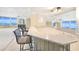 Bright living room featuring bar with ocean views, a ceiling fan, and modern finishes at 2545 S Atlantic Ave # 2107-2108, Daytona Beach Shores, FL 32118