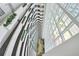 View from the top of a high-rise atrium, featuring curved balconies with planters at 2545 S Atlantic Ave # 2107-2108, Daytona Beach Shores, FL 32118