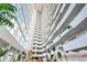Impressive atrium with towering ceilings, curved balconies, and lush tropical landscaping at 2545 S Atlantic Ave # 2107-2108, Daytona Beach Shores, FL 32118