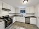 Modern kitchen featuring white shaker cabinets and stainless steel appliances at 1111 28Th Nw St, Winter Haven, FL 33881