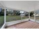 Relaxing screened porch with wood deck overlooking backyard at 1111 28Th Nw St, Winter Haven, FL 33881