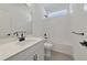 This bathroom features a large sink, matte black hardware, tiled shower-bath, and white walls at 231 Severn Way # 36, Orlando, FL 32803