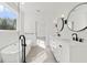 Elegant bathroom featuring double vanity, a soaking tub, and bright lighting at 231 Severn Way # 36, Orlando, FL 32803