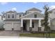 Elegant two-story home featuring a stone-accented porch, attached two-car garage and brick paver driveway at 231 Severn Way # 36, Orlando, FL 32803