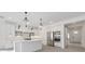 Modern white kitchen with stainless steel appliances, pendant lighting, and a center island at 231 Severn Way # 36, Orlando, FL 32803