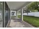 Covered patio with brick pavers overlooks the backyard at 231 Severn Way # 36, Orlando, FL 32803