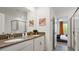 Bright bathroom featuring double vanity, modern fixtures, and a glass-enclosed shower at 2726 Oxymoron Way, Kissimmee, FL 34746