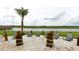 Relaxing outdoor beach area with comfortable seating and beautiful lake view at 2726 Oxymoron Way, Kissimmee, FL 34746