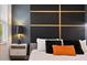 Modern bedroom with dark accent wall, minimalist decor, and a comfortable bed at 2726 Oxymoron Way, Kissimmee, FL 34746