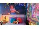 Bright themed bedroom featuring colorful wall art and decor with flower accents at 2726 Oxymoron Way, Kissimmee, FL 34746