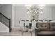 Elegant dining room with decorative wall paneling, modern chandelier, and stylish furnishings at 2726 Oxymoron Way, Kissimmee, FL 34746