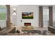 Cozy living room featuring modern fireplace, large screen TV, and comfortable furnishings at 2726 Oxymoron Way, Kissimmee, FL 34746