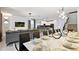 Open-concept living space with dining area and kitchen featuring modern decor and natural light at 2726 Oxymoron Way, Kissimmee, FL 34746