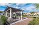 Outdoor pergola featuring stone pillars and brick accents, providing an attractive gathering spot at 2726 Oxymoron Way, Kissimmee, FL 34746