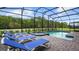 Inviting screened-in pool area with comfortable lounge chairs and a relaxing spa at 2726 Oxymoron Way, Kissimmee, FL 34746