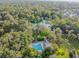 Community pool and surrounding lush landscape at 213 Crown Oaks Way # 213, Longwood, FL 32779