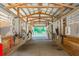 Long row of barn stalls with horses and ceiling fans at 213 Crown Oaks Way # 213, Longwood, FL 32779