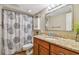 Updated bathroom with granite countertop, shower, and stylish shower curtain at 213 Crown Oaks Way # 213, Longwood, FL 32779