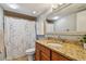 Bathroom with granite countertop and shower at 213 Crown Oaks Way # 213, Longwood, FL 32779