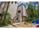 Exterior view of condo building with stairs and landscaping at 213 Crown Oaks Way # 213, Longwood, FL 32779