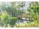 Wooden footbridge crossing a calm, clear stream at 213 Crown Oaks Way # 213, Longwood, FL 32779