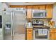 Stainless steel refrigerator and stove in updated kitchen at 213 Crown Oaks Way # 213, Longwood, FL 32779