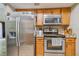 Stainless steel appliances and wood cabinets feature in this galley kitchen at 213 Crown Oaks Way # 213, Longwood, FL 32779