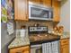 Stainless steel appliances and wood cabinets in kitchen at 213 Crown Oaks Way # 213, Longwood, FL 32779