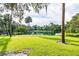 Serene lakefront view with lush landscaping and palm trees at 213 Crown Oaks Way # 213, Longwood, FL 32779