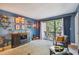 Living room with blue walls, wood accents and sliding doors to balcony at 213 Crown Oaks Way # 213, Longwood, FL 32779