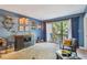 Blue living room with balcony access and stylish mid century furniture at 213 Crown Oaks Way # 213, Longwood, FL 32779