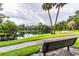 Relaxing park bench overlooking a tranquil lake at 213 Crown Oaks Way # 213, Longwood, FL 32779