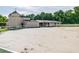 Spacious sand riding arena with white post and rail fencing and barn at 213 Crown Oaks Way # 213, Longwood, FL 32779