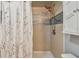 Updated shower with tile surround and modern fixtures at 213 Crown Oaks Way # 213, Longwood, FL 32779