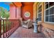 Brick porch with seating area and red railings at 2107 Westover Reserve Blvd, Windermere, FL 34786