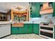 Modern kitchen featuring copper sink, range, and green cabinets at 2107 Westover Reserve Blvd, Windermere, FL 34786