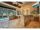 Outdoor kitchen with bar, grill, and tropical decor at 2107 Westover Reserve Blvd, Windermere, FL 34786